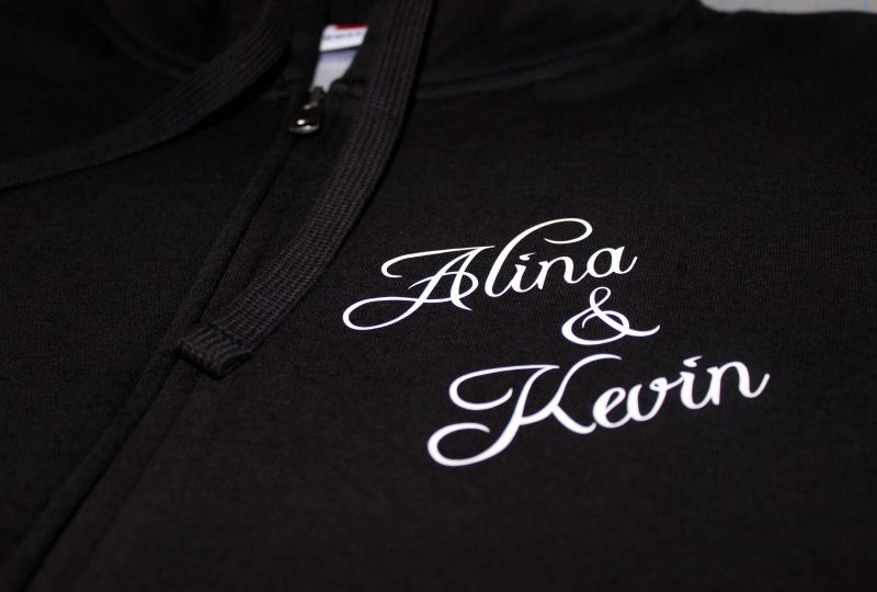 Wunschtextaufdruck auf eine mitgebrachte Sweatjacke vom Kunden.